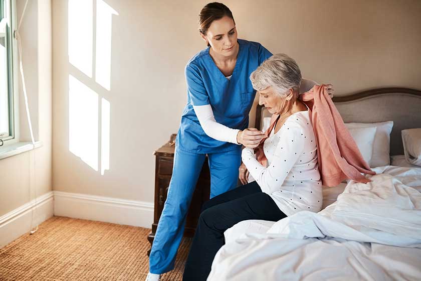 One day well all need a bit of extra help. a young nurse helping a senior woman get dressed in her bedroom at a nursing home